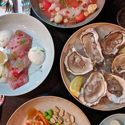 Tapas plates of ceviche, oysters and salmon